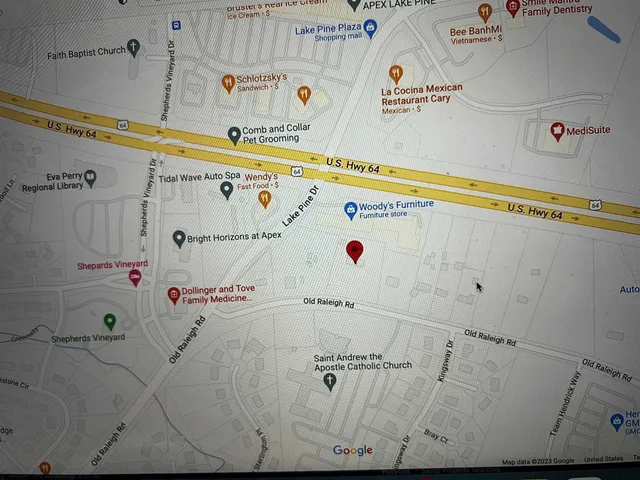 a kitchen with stainless steel appliances granite countertop a refrigerator a sink a stove and a refrigerator