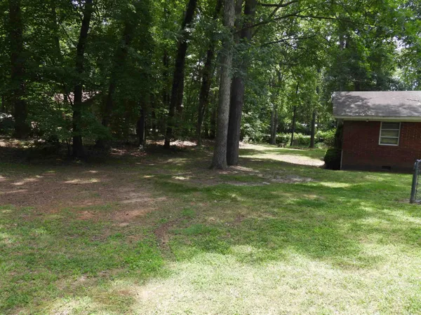 a view of a house with a yard and swimming pool