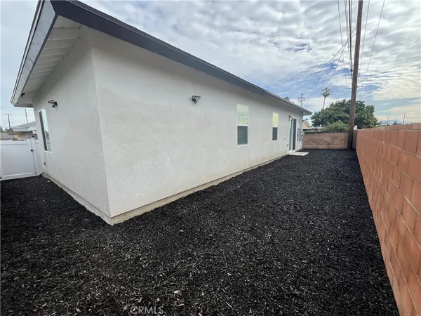 a view of a backyard with pathway and a building