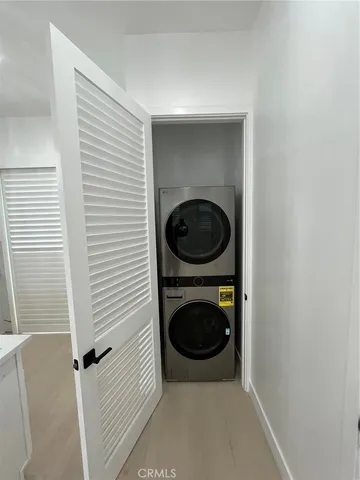 a view of a hallway with washer and dryer
