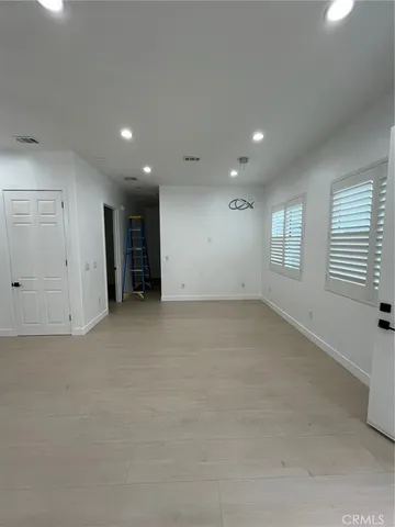 an empty room with a window and a mirror