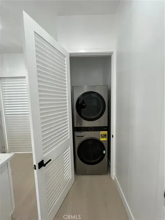 a view of a hallway with washer and dryer