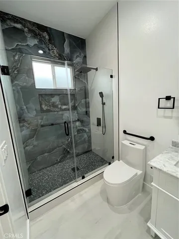 a bathroom with a shower and a toilet