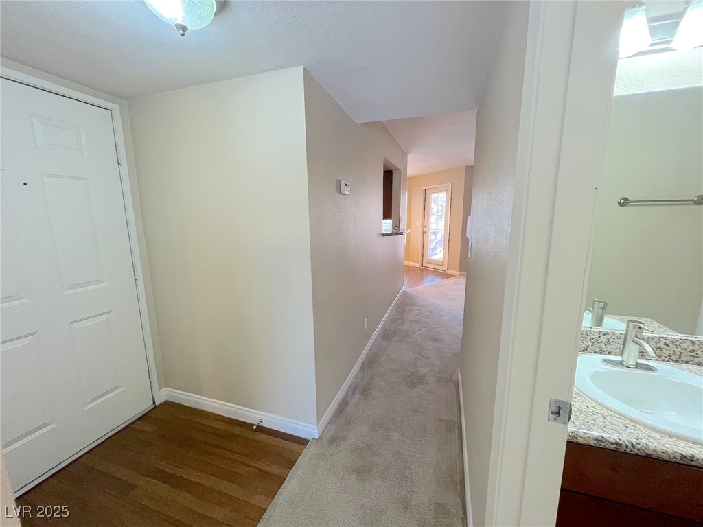 2750 South Durango Drive, Unit 2139 Las Vegas, NV 89117 - Photo 11 of 21 Corridor featuring dark colored carpet and dark wood finished floors