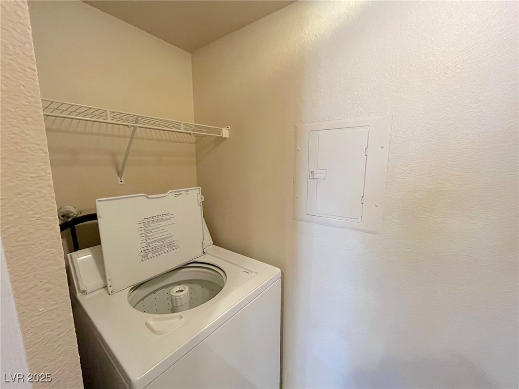 2750 South Durango Drive, Unit 2139 Las Vegas, NV 89117 - Photo 8 of 21 Laundry room featuring washer / clothes dryer, electric panel, and a textured wall