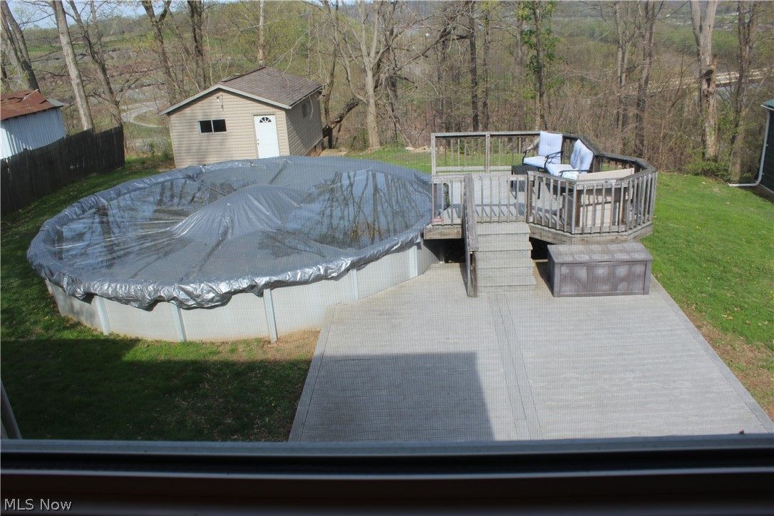 899 River Hill Road Washington, WV 26181 - Photo 14 of 15 View of above ground pool, deck and storage shed in the backyard.