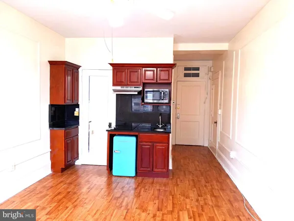 a kitchen view with a sink and refrigerator