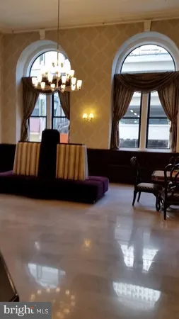 a living room with large couches and chandelier