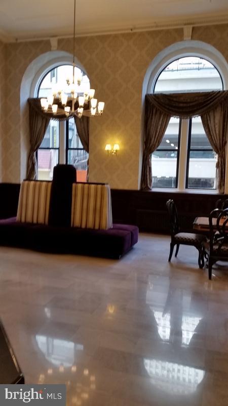 1324 Locust Street, Unit 1421 Philadelphia, PA 19107 - Photo 8 of 15 a living room with large couches and chandelier