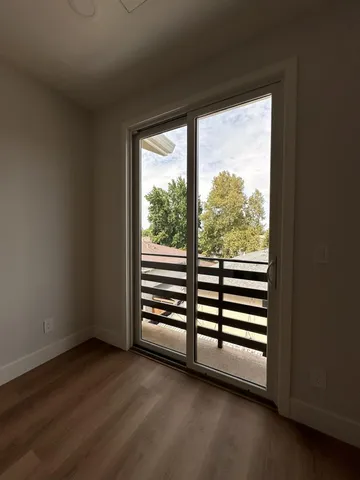 a view of entryway and hall with wooden floor