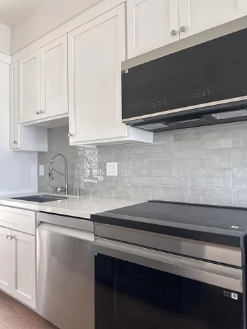 a kitchen with a sink and cabinets