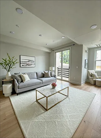 a living room with furniture and wooden floor