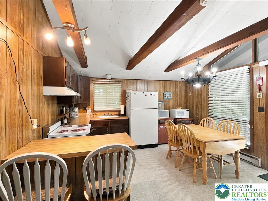 116 Aspen Road Albrightsville, PA 18210 - Photo 23 of 33 Exposed wood beams and matching wall paneling bring rustic warmth to this open kitchen area.
