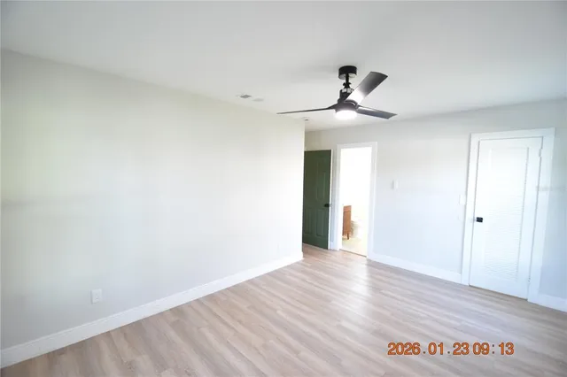 a view of an empty room and wooden floor