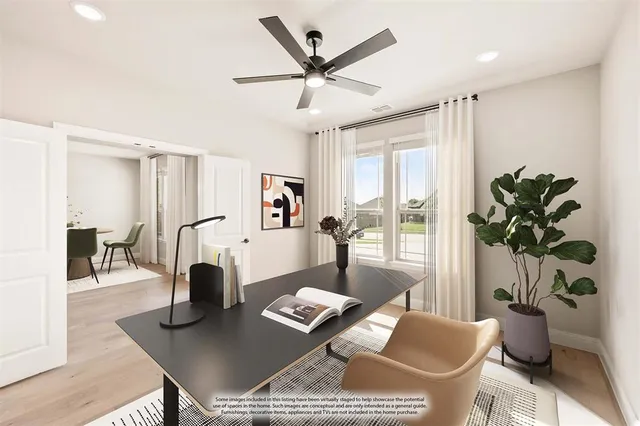 an empty room with wooden floor and ceiling fan