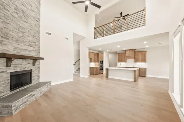 a kitchen with stainless steel appliances kitchen island granite countertop a sink stove and refrigerator