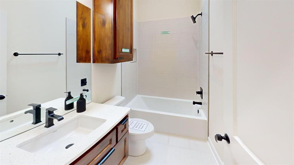 2509 Windmill Lane Longview, TX 75601 - Photo 18 of 35 Full bathroom featuring vanity, shower / bathtub combination, and tile patterned flooring