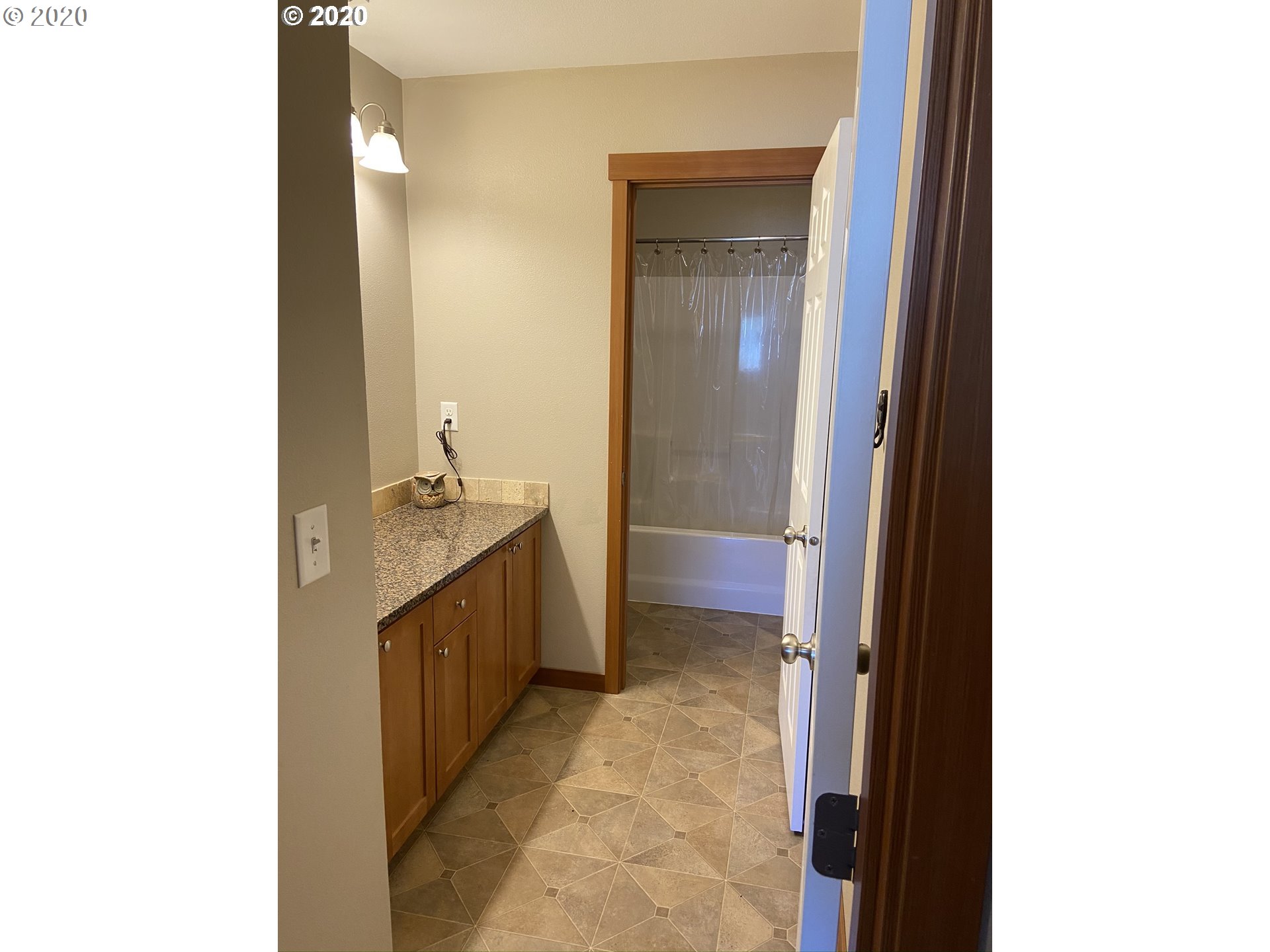 1998 Pruner Road Riddle, OR 97469 - Photo 13 of 22 a bathroom with a granite countertop sink a mirror and a bathtub