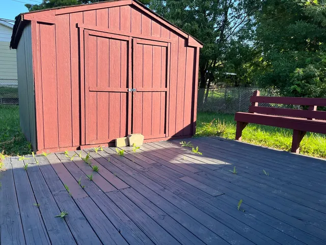 a view of a backyard with wooden floor