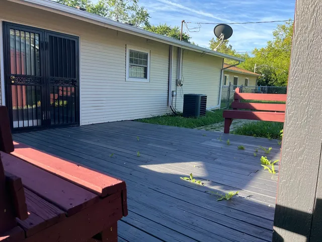 a wooden bench sitting in front of a building