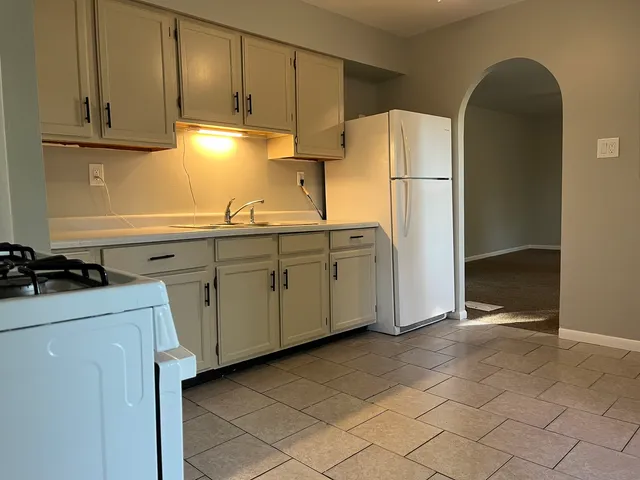 a kitchen with stainless steel appliances granite countertop a refrigerator sink and cabinets