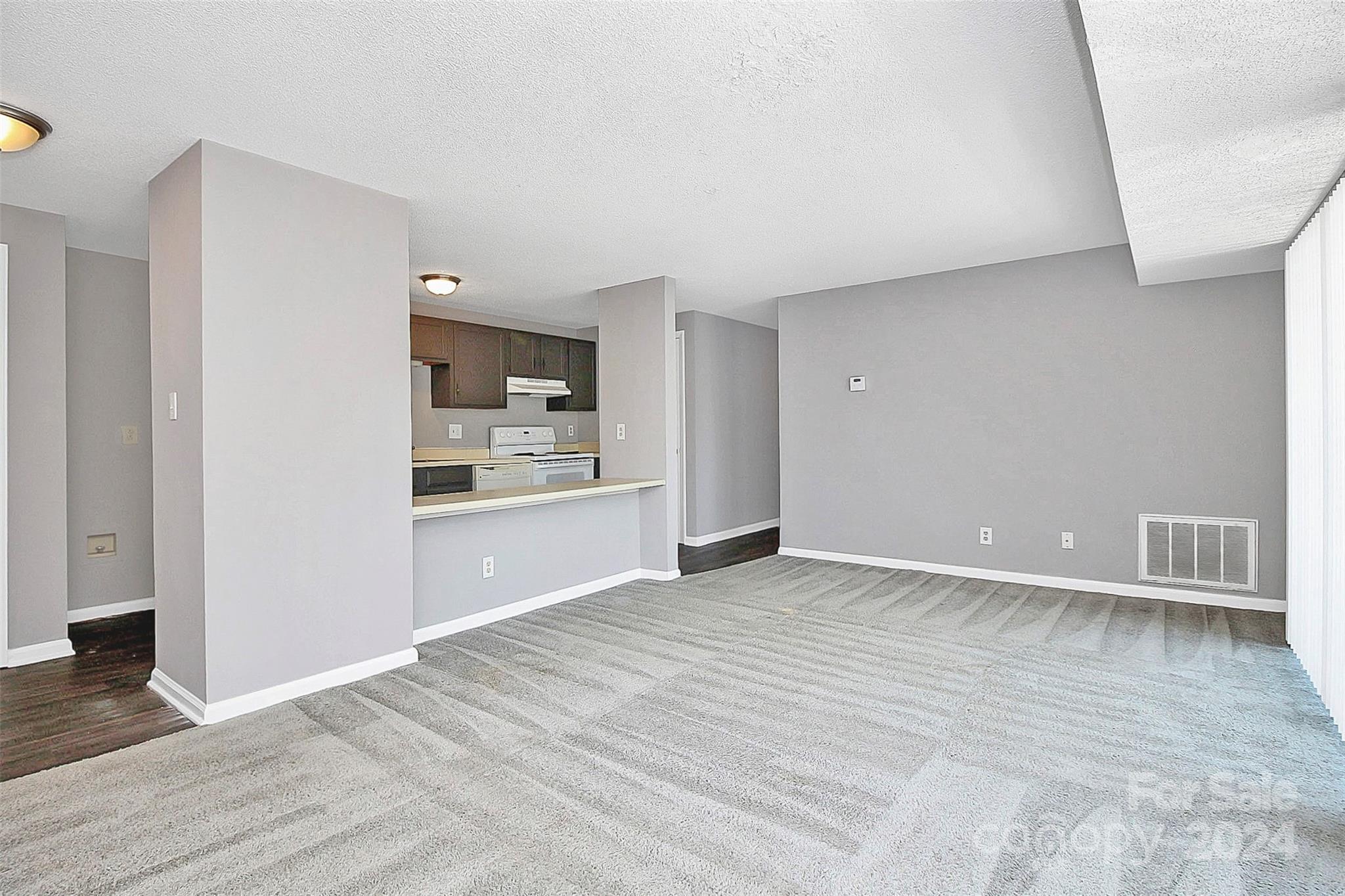 9409 Old Concord Road, Unit M Charlotte, NC 28213 - Photo 13 of 29 a view of an empty room with kitchen and window