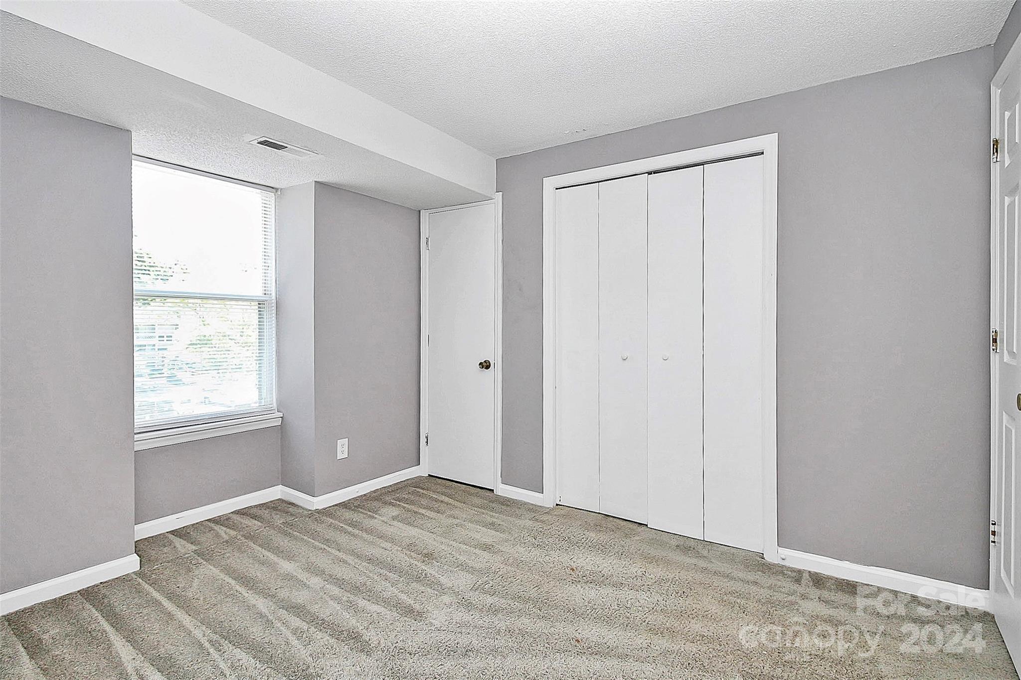 9409 Old Concord Road, Unit M Charlotte, NC 28213 - Photo 22 of 29 a view of an empty room with wooden floor and a window