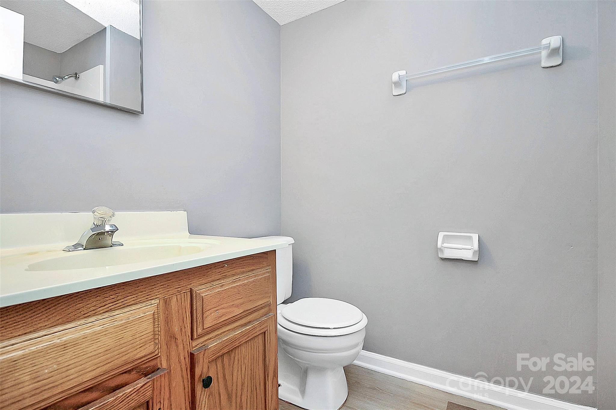 9409 Old Concord Road, Unit M Charlotte, NC 28213 - Photo 24 of 29 a bathroom with a granite countertop toilet sink and mirror