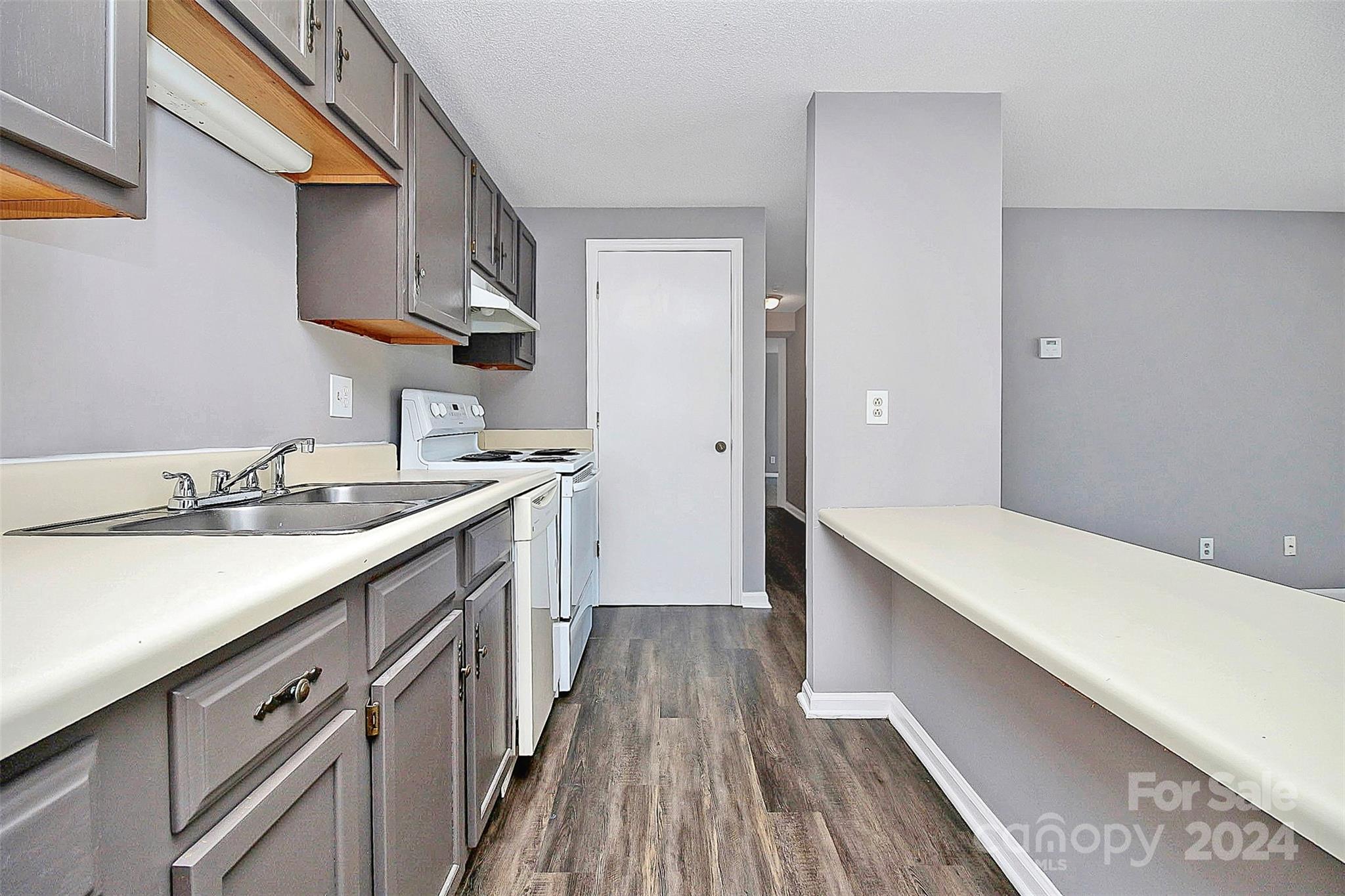 9409 Old Concord Road, Unit M Charlotte, NC 28213 - Photo 5 of 29 a kitchen with a sink and wooden floor