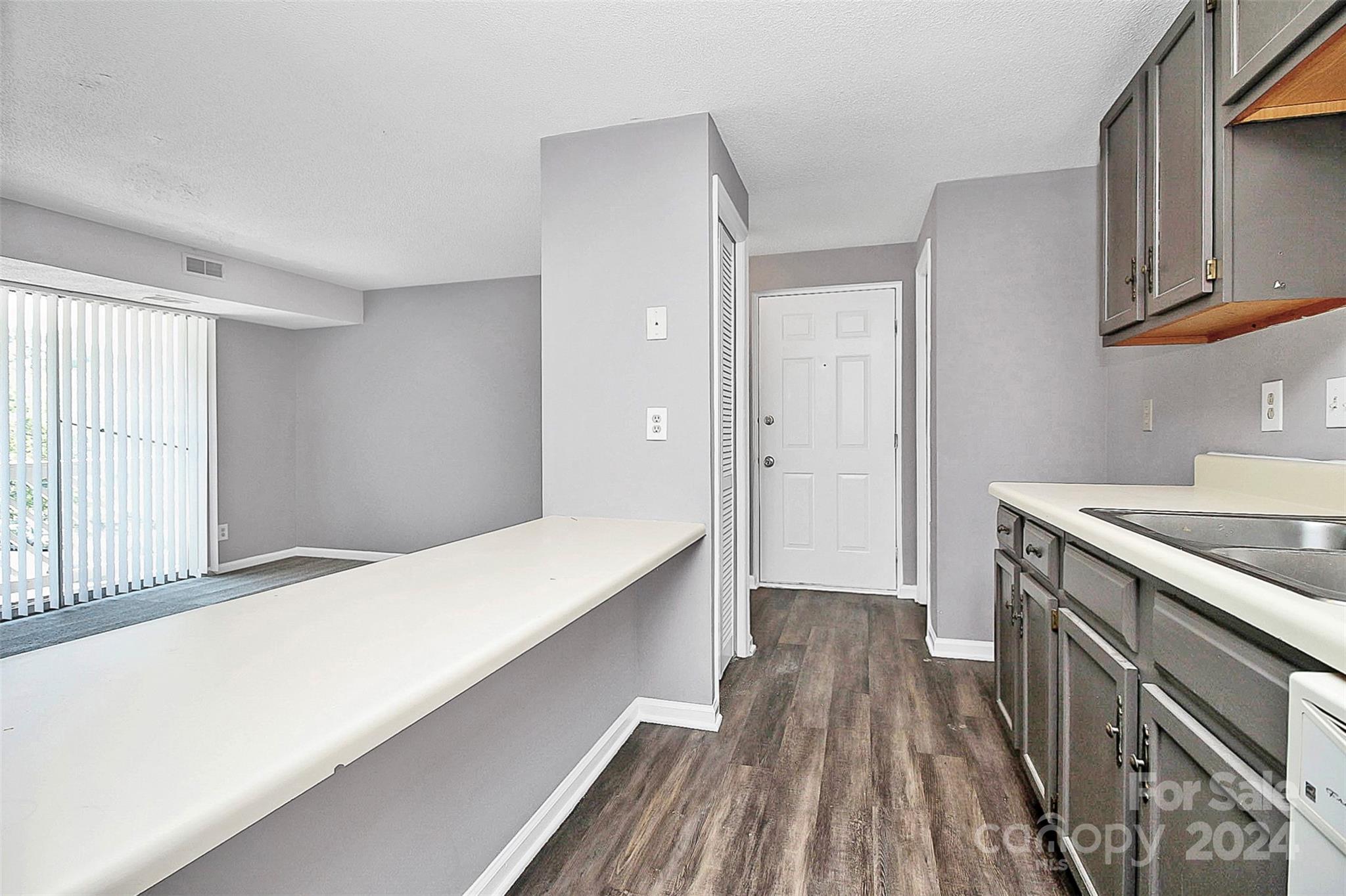 9409 Old Concord Road, Unit M Charlotte, NC 28213 - Photo 6 of 29 a kitchen with a sink and wooden floor