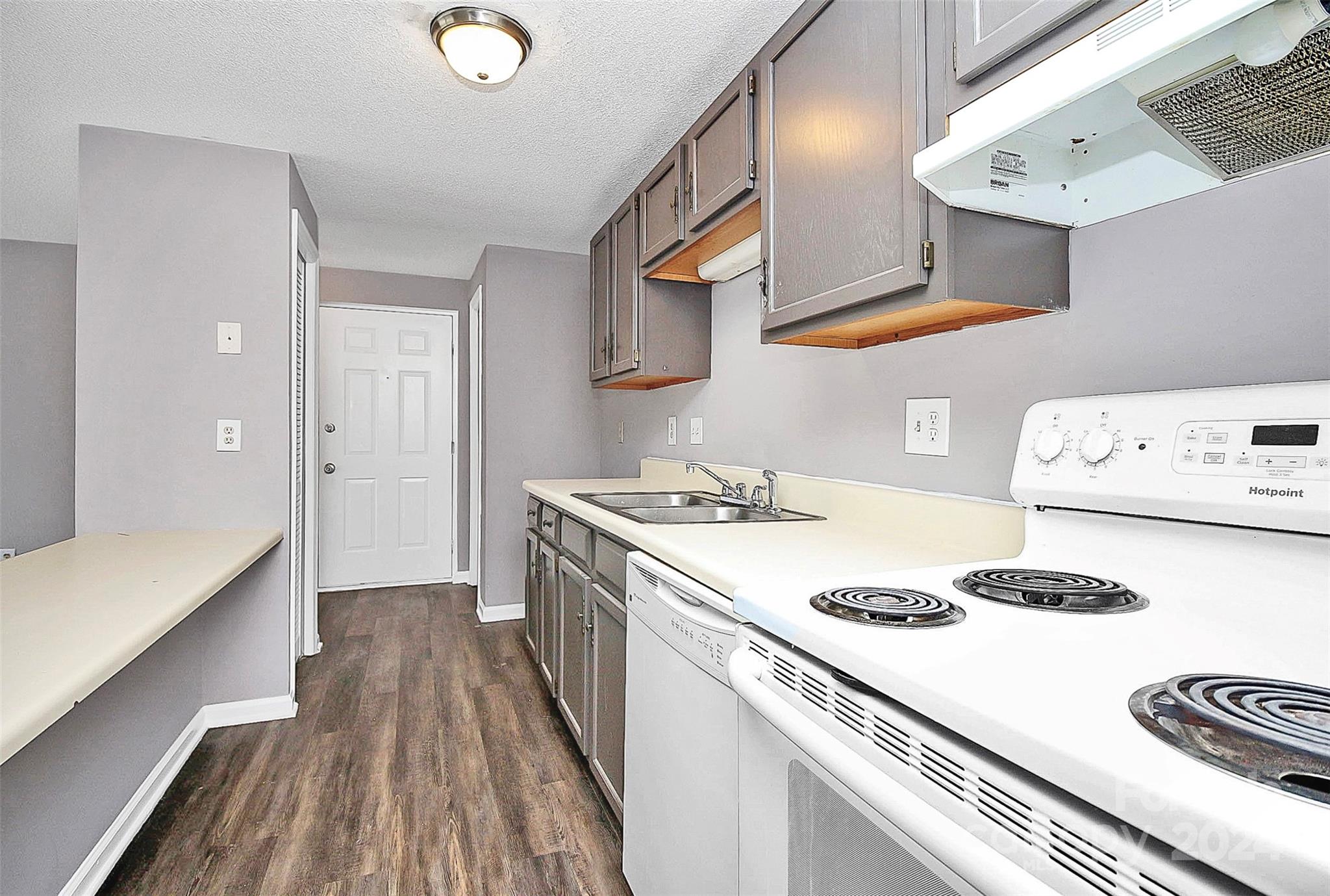 9409 Old Concord Road, Unit M Charlotte, NC 28213 - Photo 7 of 29 a kitchen with a sink a stove and cabinets