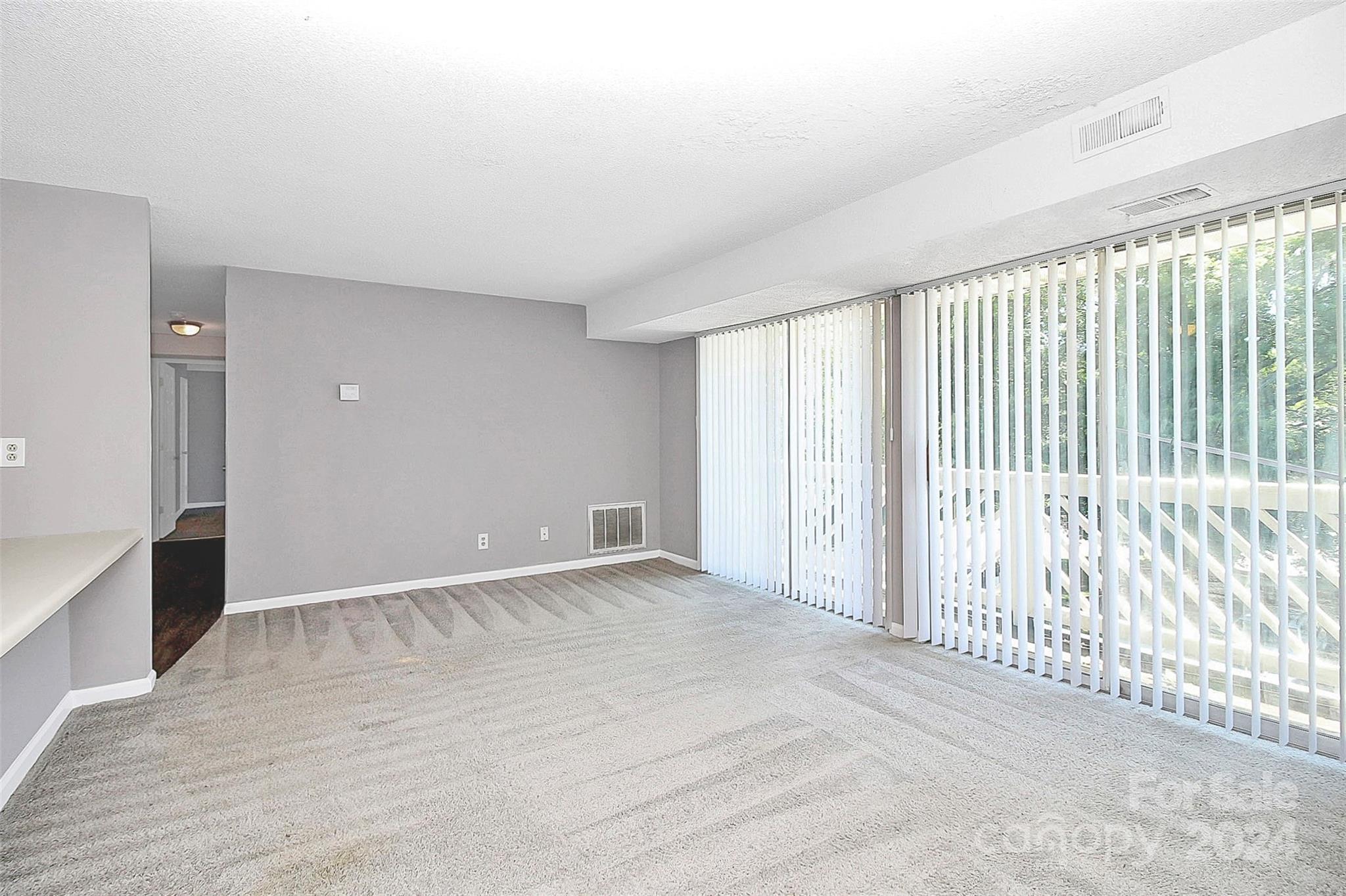 9409 Old Concord Road, Unit M Charlotte, NC 28213 - Photo 10 of 29 a view of an empty room with wooden floor