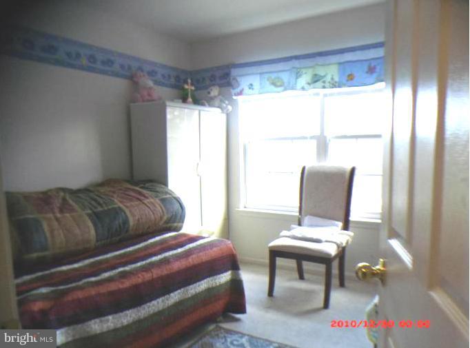 7013 Friendship Road Clinton, MD 20735 - Photo 4 of 15 a bedroom with a bed and a window