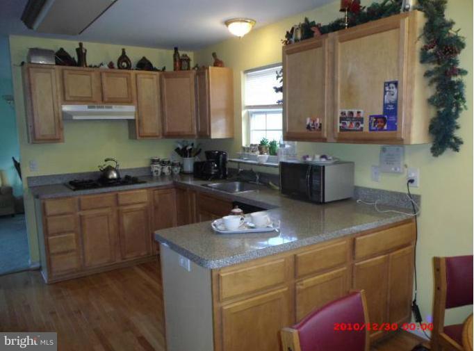 7013 Friendship Road Clinton, MD 20735 - Photo 5 of 15 a kitchen with stainless steel appliances granite countertop a sink dishwasher stove and cabinets