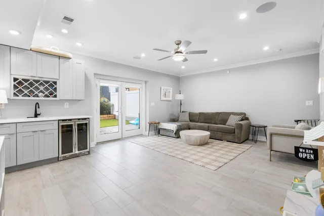 a living room with furniture a ceiling fan and a rug