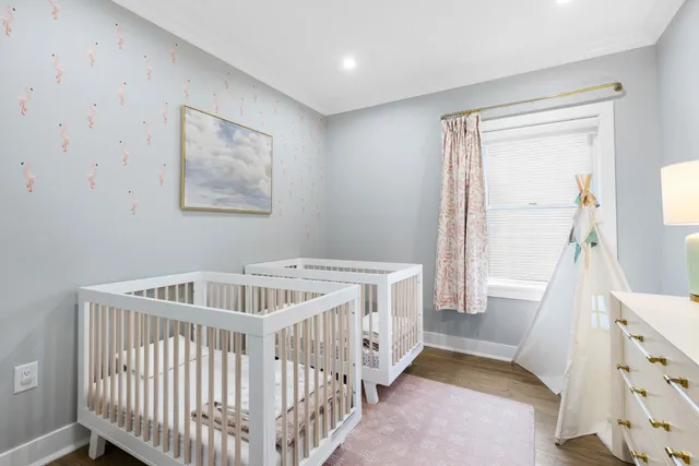 a bedroom with furniture and baby crib