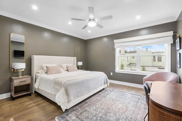 a bedroom with a large bed and a large window