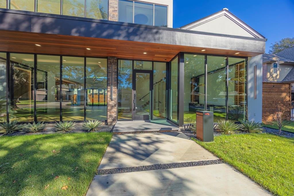 Property entrance featuring a yard and a patio