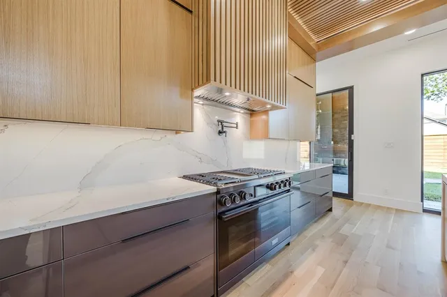 a kitchen with a sink and wooden floor