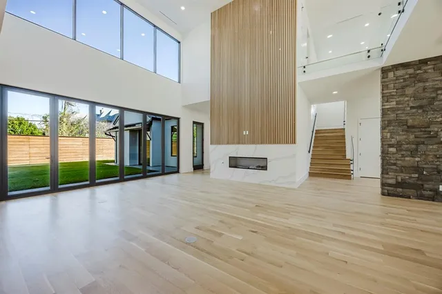 wooden floor in a hall with a large window