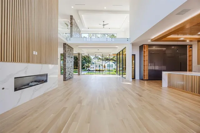 a view of an empty room with a kitchen view