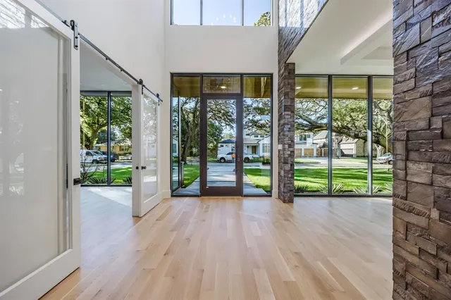 a view of porch with a floor to ceiling window next to a yard