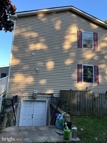 a view of house with backyard and sitting area