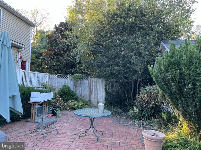 a view of a chair and table in backyard
