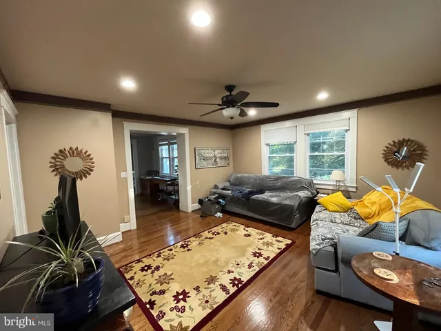 a living room with furniture pool table and a large window