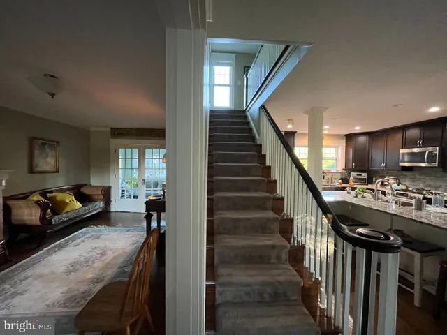 a view of a livingroom with furniture and stairs