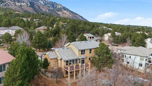 an aerial view of a house with yard and mountain view