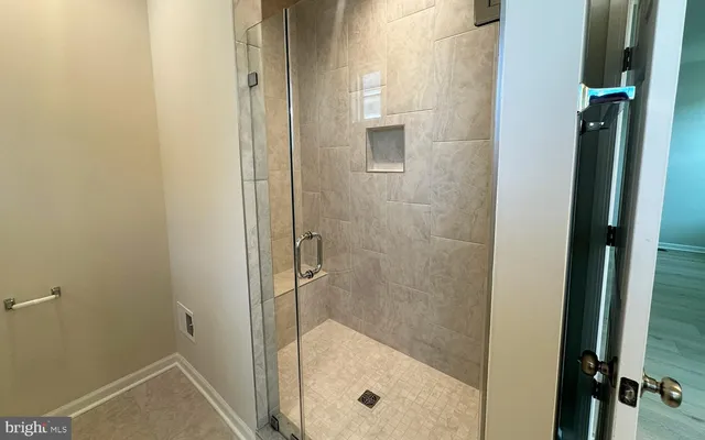 a bathroom with a glass shower door
