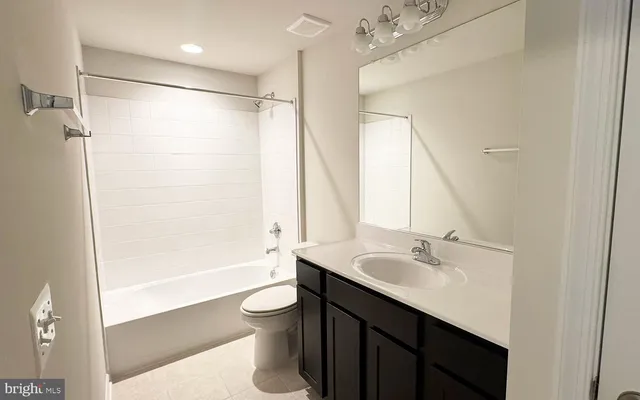a bathroom with a sink double vanity mirror and a bathtub