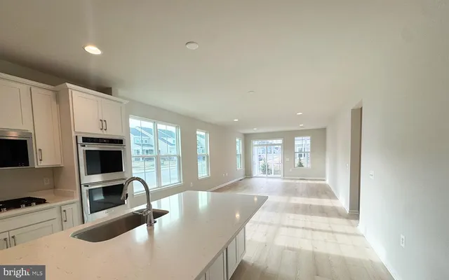 a view of a kitchen with a sink and a fireplace